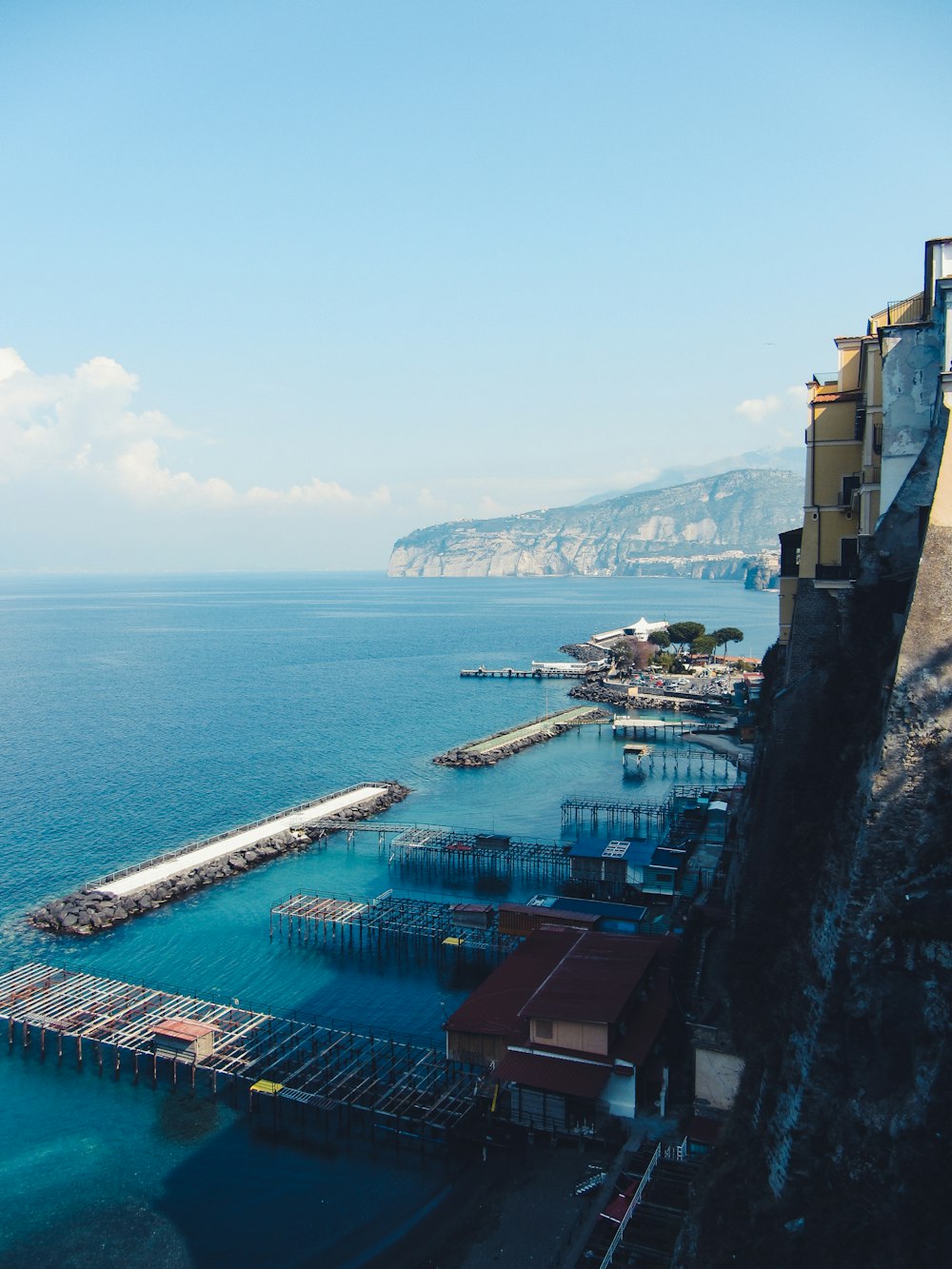 a large body of water next to a hillside