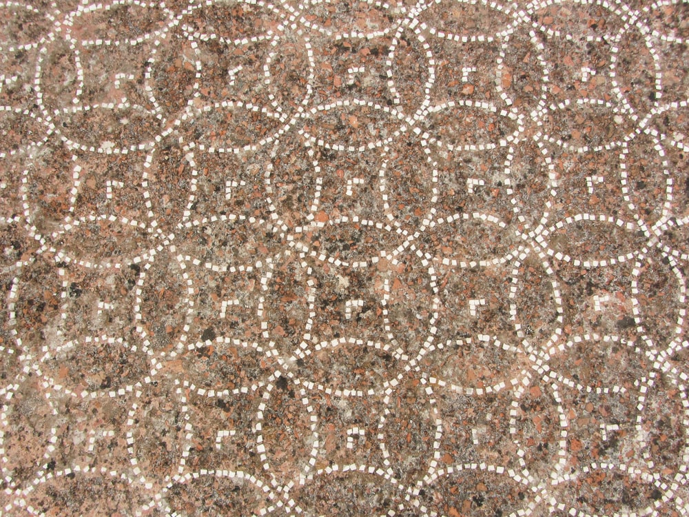 a close up of a pattern on a stone surface