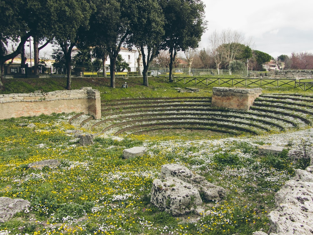 a large stone structure sitting in the middle of a lush green field