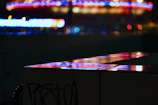 A vibrant movie poster featuring an intense action scene under neon city lights.