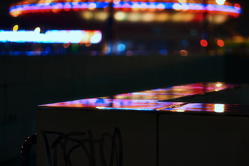 Close-up of a rare Free Fire skin glowing under neon lights in a night cityscape.