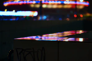 A vibrant movie poster featuring an intense action scene under neon city lights.