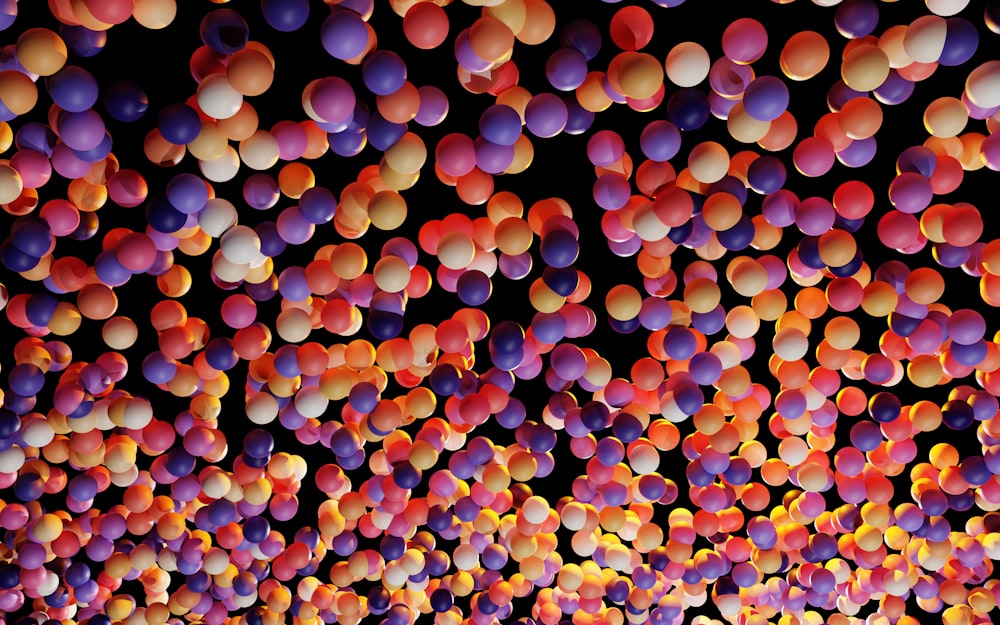 a large group of balloons floating in the air