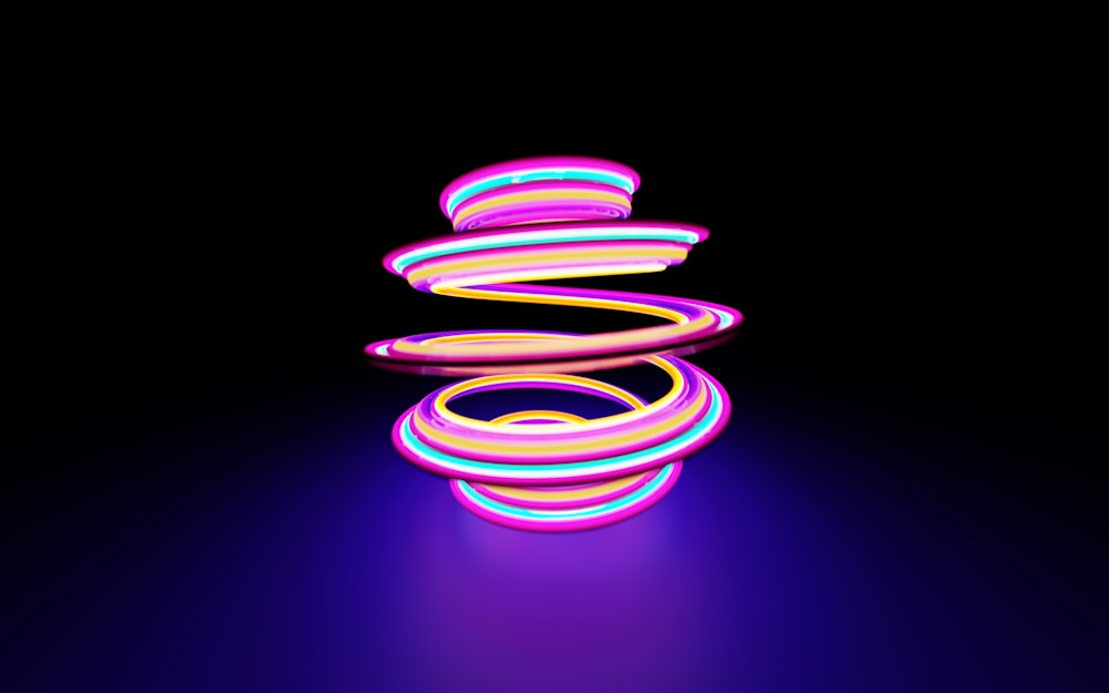 Un objet lumineux violet et rose sur fond noir photo – Photo Spirale  Gratuite sur Unsplash