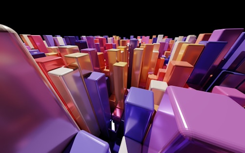 A collection of colorful, glossy, rectangular prisms arranged closely together, creating a sense of depth and perspective. The prisms display various shades of purple, orange, red, and blue, against a black backdrop, giving a vibrant and dynamic appearance.