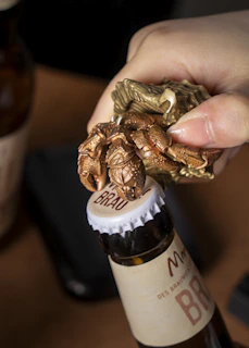 A bartender swiftly opening a beer bottle with the compact Flash Bar Pro under vibrant club lighting.