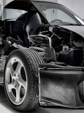 a black and white photo of a car with its hood open