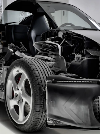 Sliding view of a car undergoing wheel installation at a professional shop.