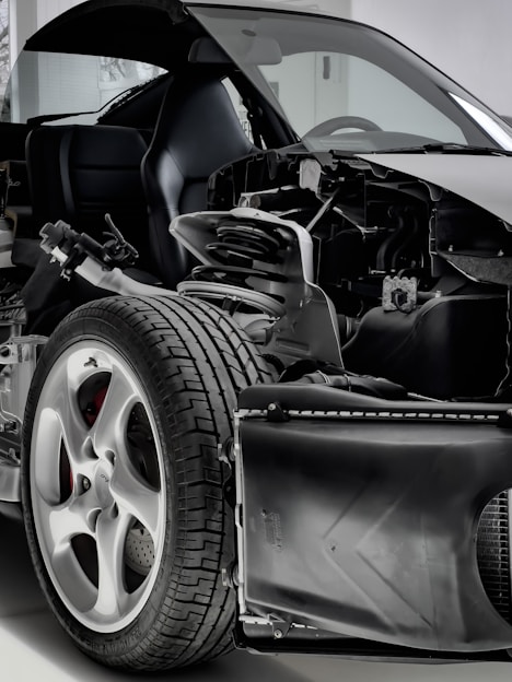 a black and white photo of a car with its hood open