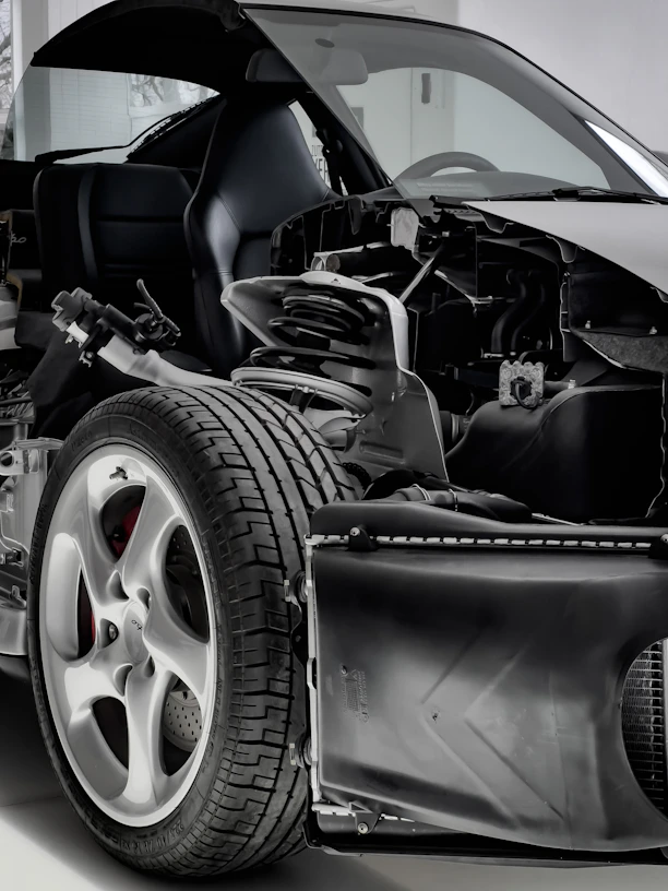 a black and white photo of a car with its hood open