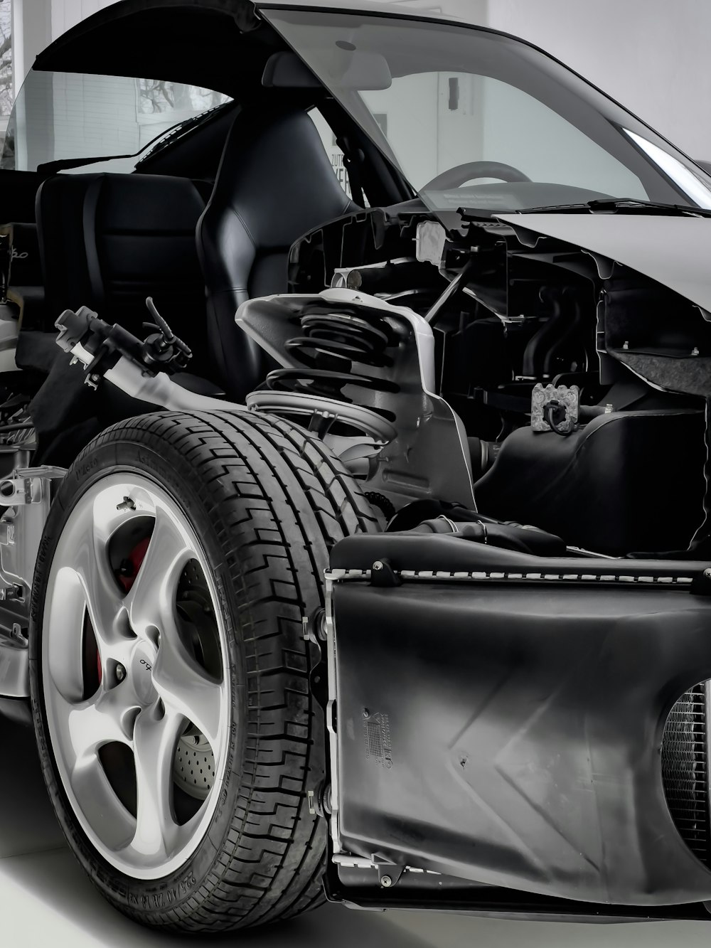 a black and white photo of a car with its hood open