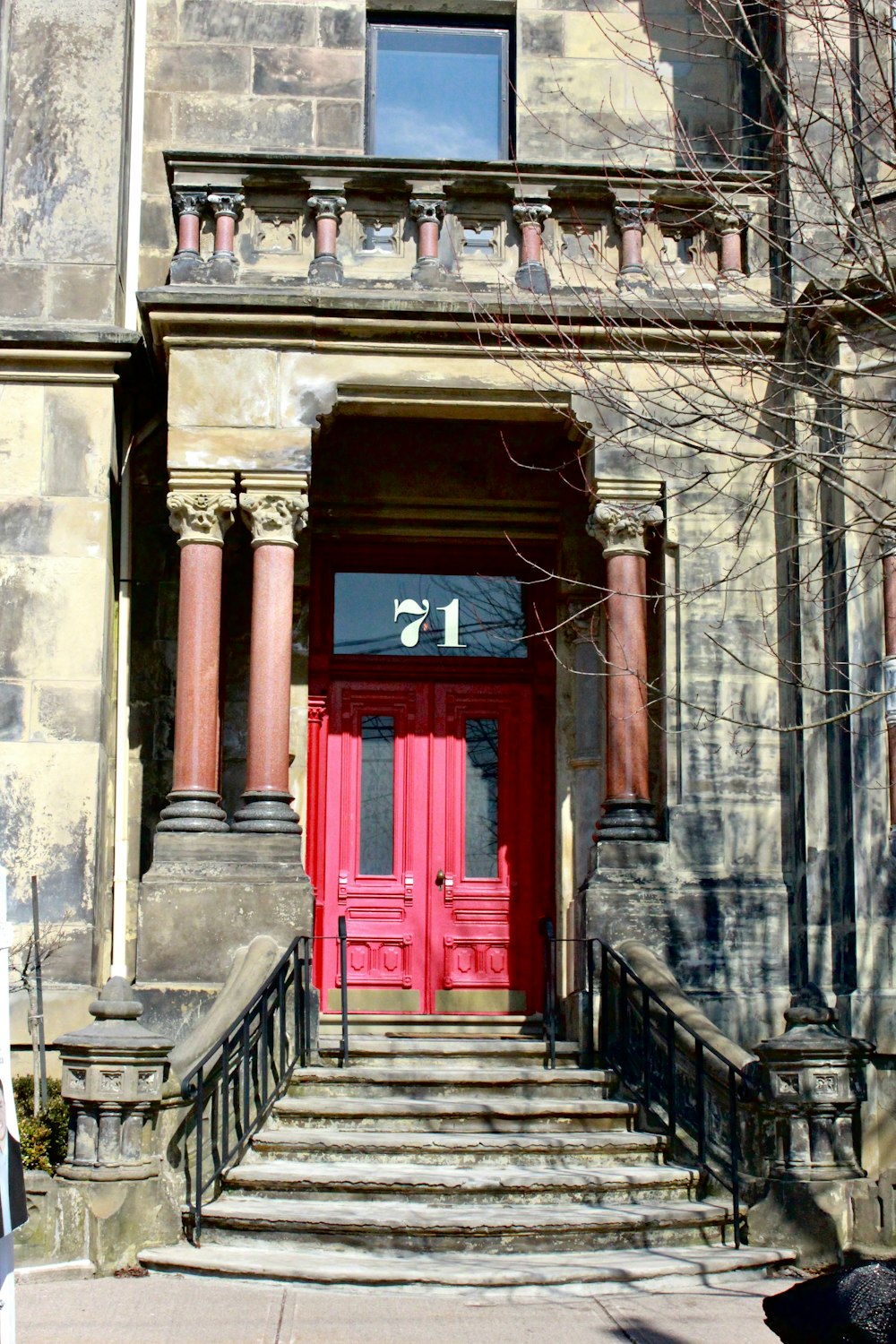 a red door is on the front of a building