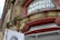 An old-style building features detailed stone carvings and a prominent red-framed shop front with the text 'Bayside Barbers' displayed. The architectural details include ornate stonework and classic design elements. A partially open white door reveals part of an address plaque reading '1 Princess'.