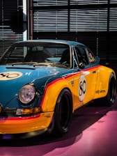 a yellow and blue sports car parked in a garage