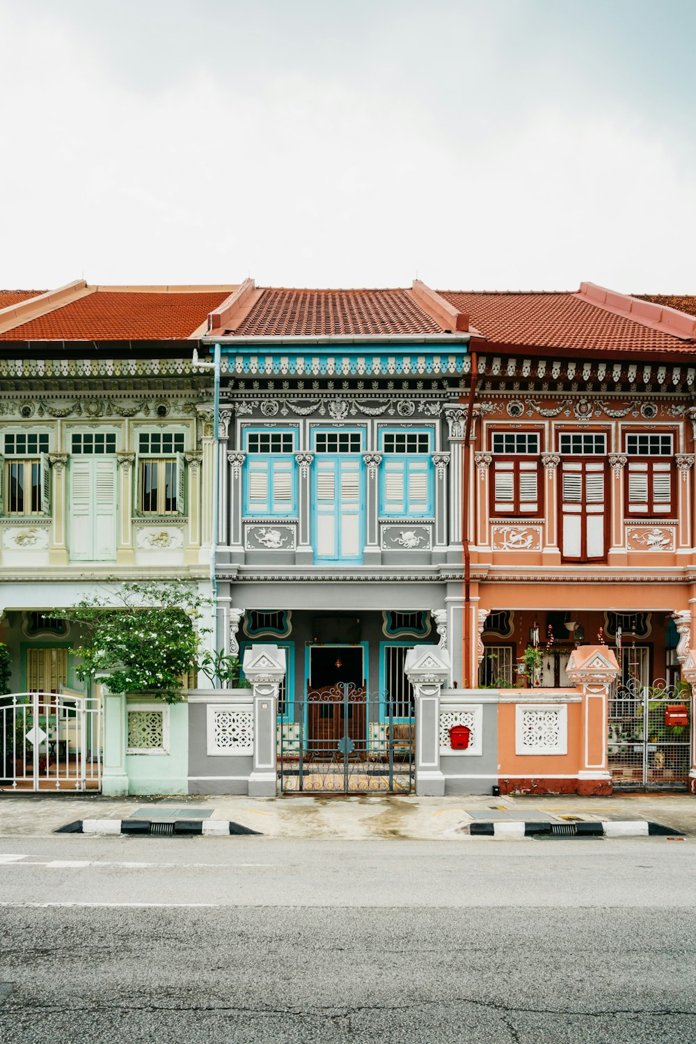 a row of multi - colored buildings on a street corner