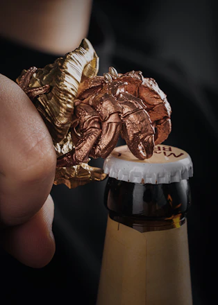 Close-up of the odpirač can opener in use at a busy pizzeria kitchen.