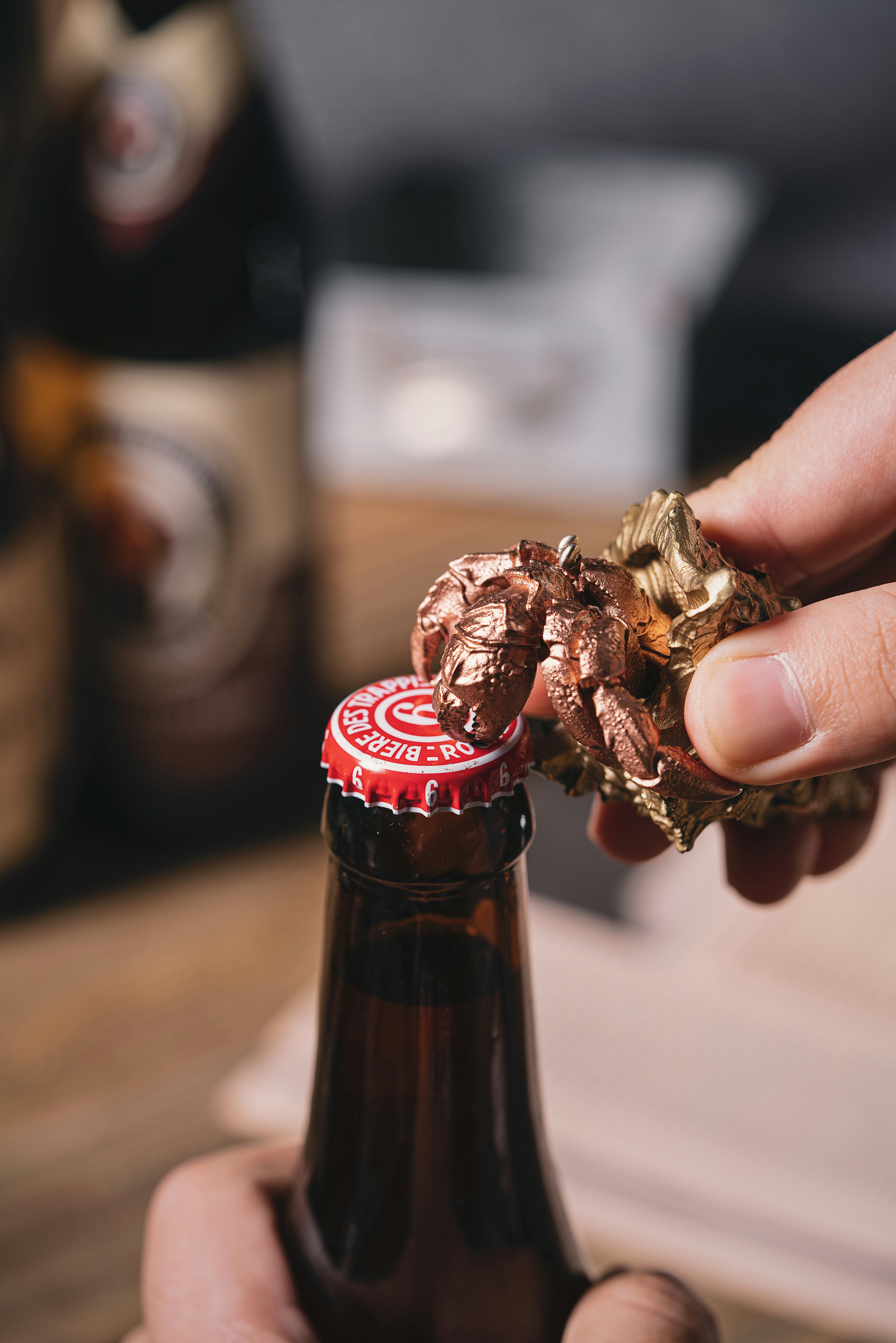 a person holding a bottle of beer and a piece of food