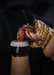 A stylish bottle opener engraved with a name, placed beside a chilled bottle.