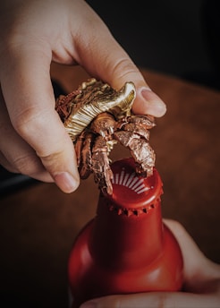 A cheerful left-handed person using a uniquely designed can opener in a bright kitchen.
