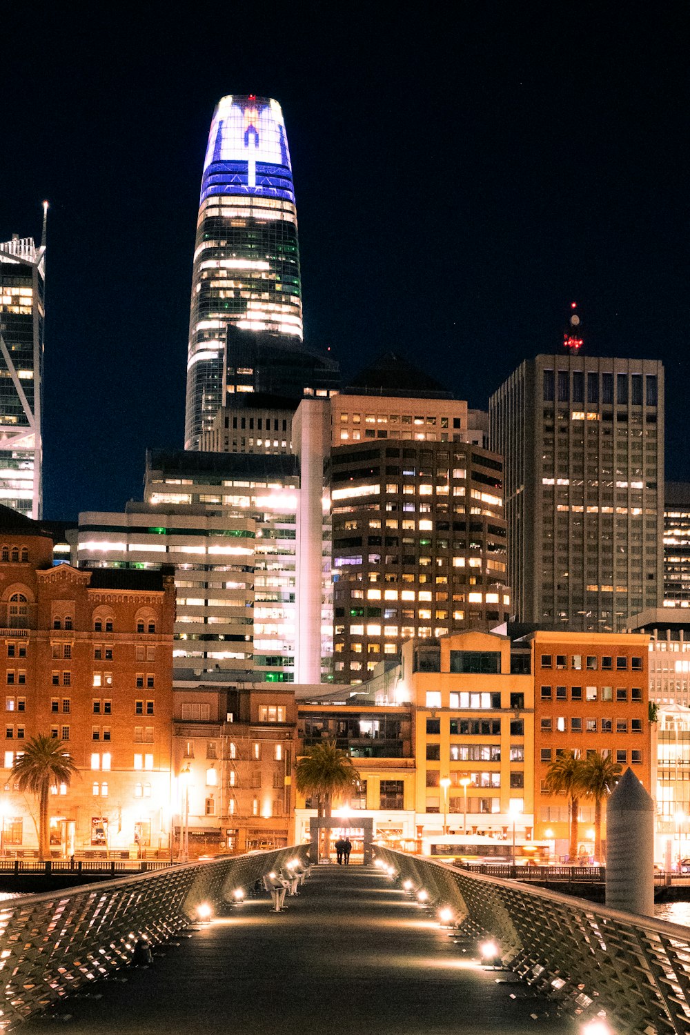 a city skyline at night with buildings lit up