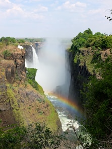 a waterfall with a rainbow in the middle of it