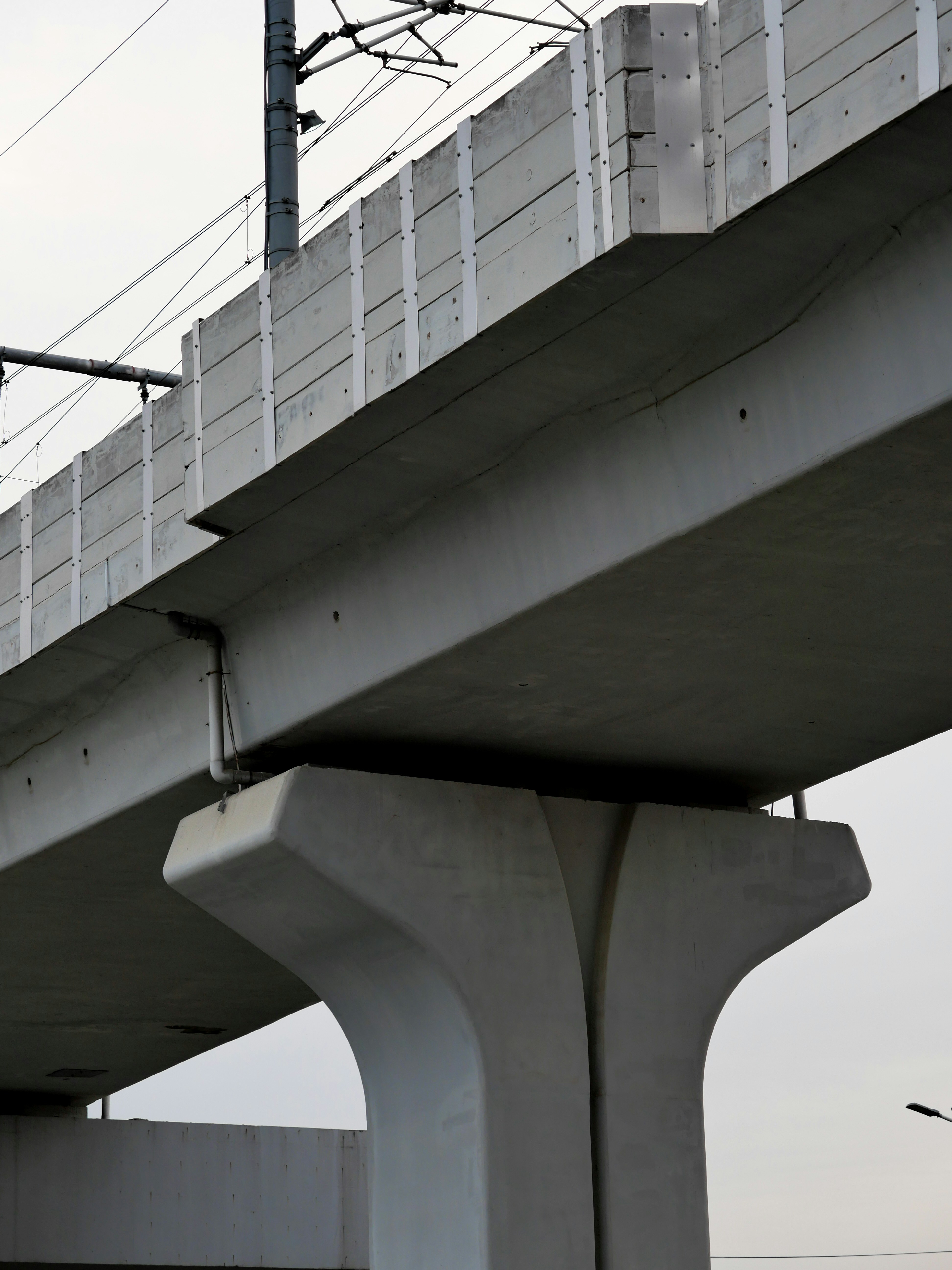 a traffic light sitting on the side of a bridge