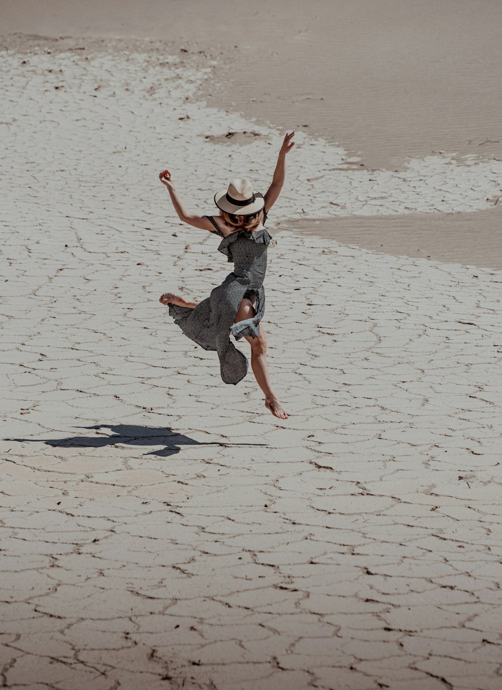 a person jumping in the air on a beach