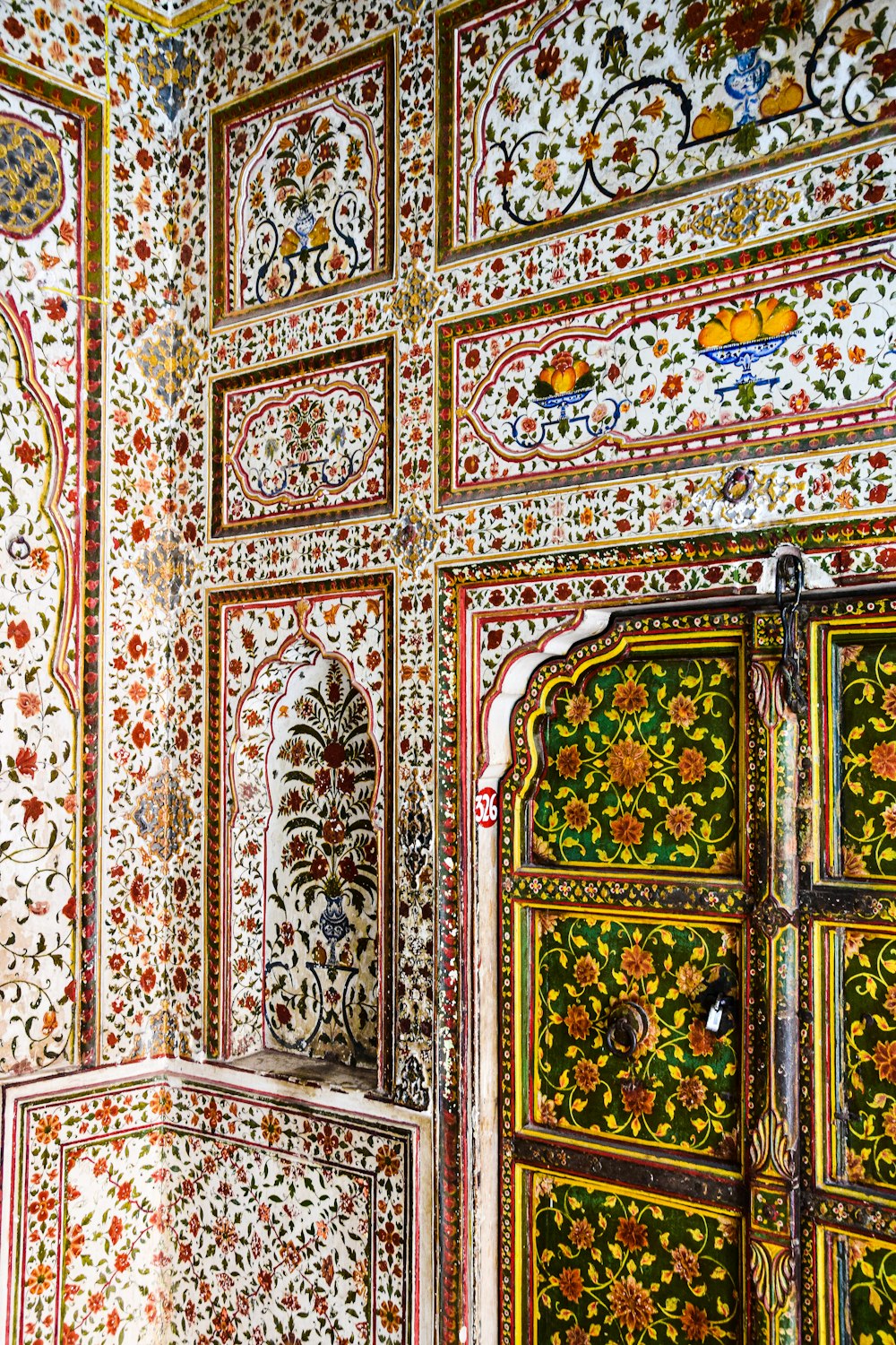 an ornately decorated room with a wooden door