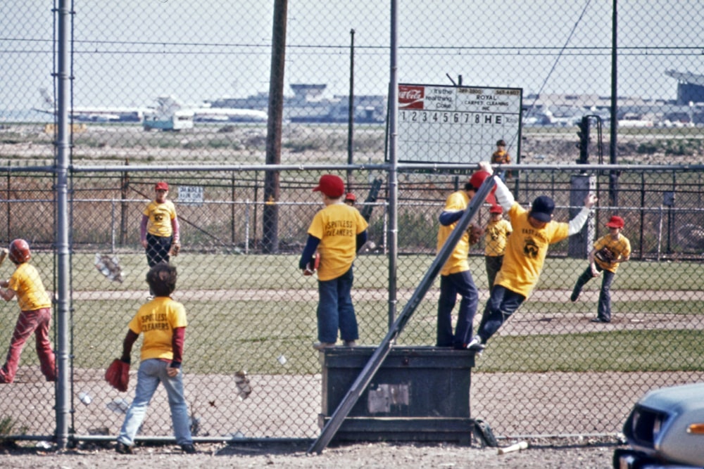 a group of young men standing on top of a baseball field