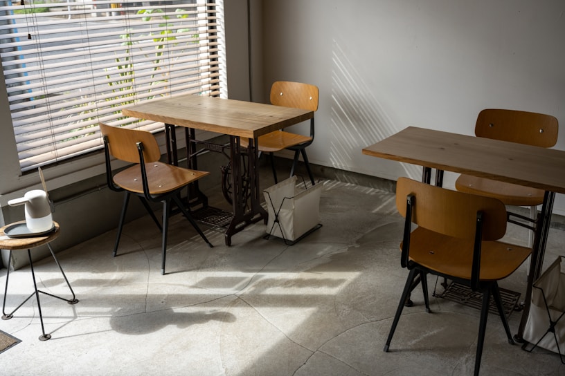 Cozy corner of the tea house with rustic wooden tables and soft natural light.