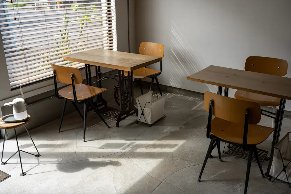 A furniture showroom display with a wooden dining table and chairs