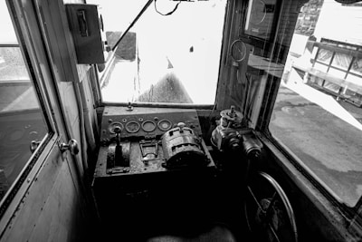 Close-up of the industrial gray control panel inside a skid steer cabin.
