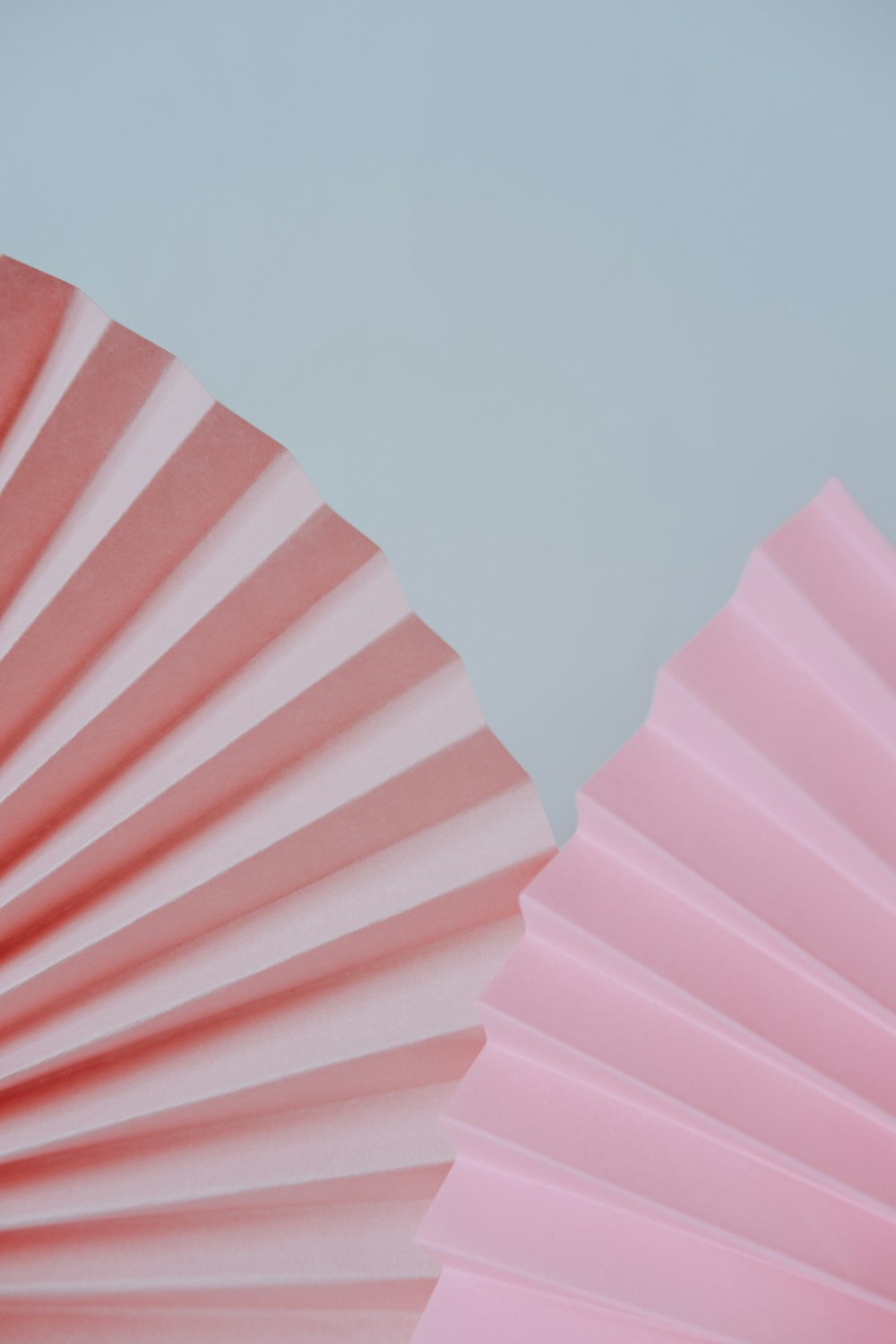 a close up of a pink paper fan