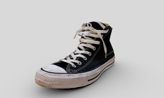 a pair of black and white sneakers with white laces