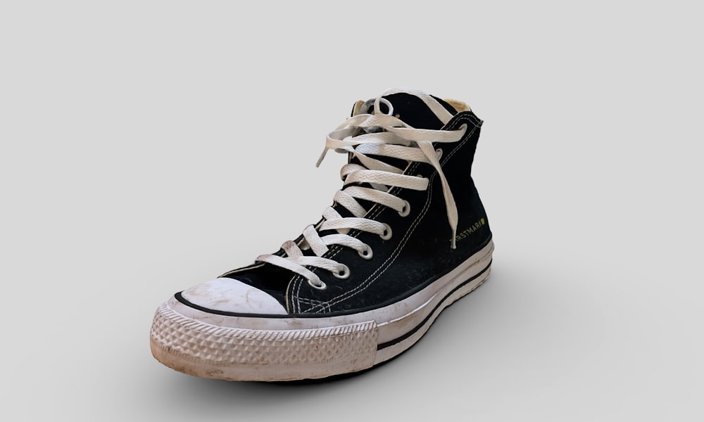 a pair of black and white sneakers with white laces