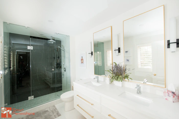 Remodeled bathroom with double sinks and glass shower