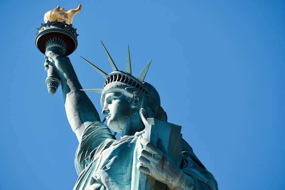 the statue of liberty is holding a torch in its hand