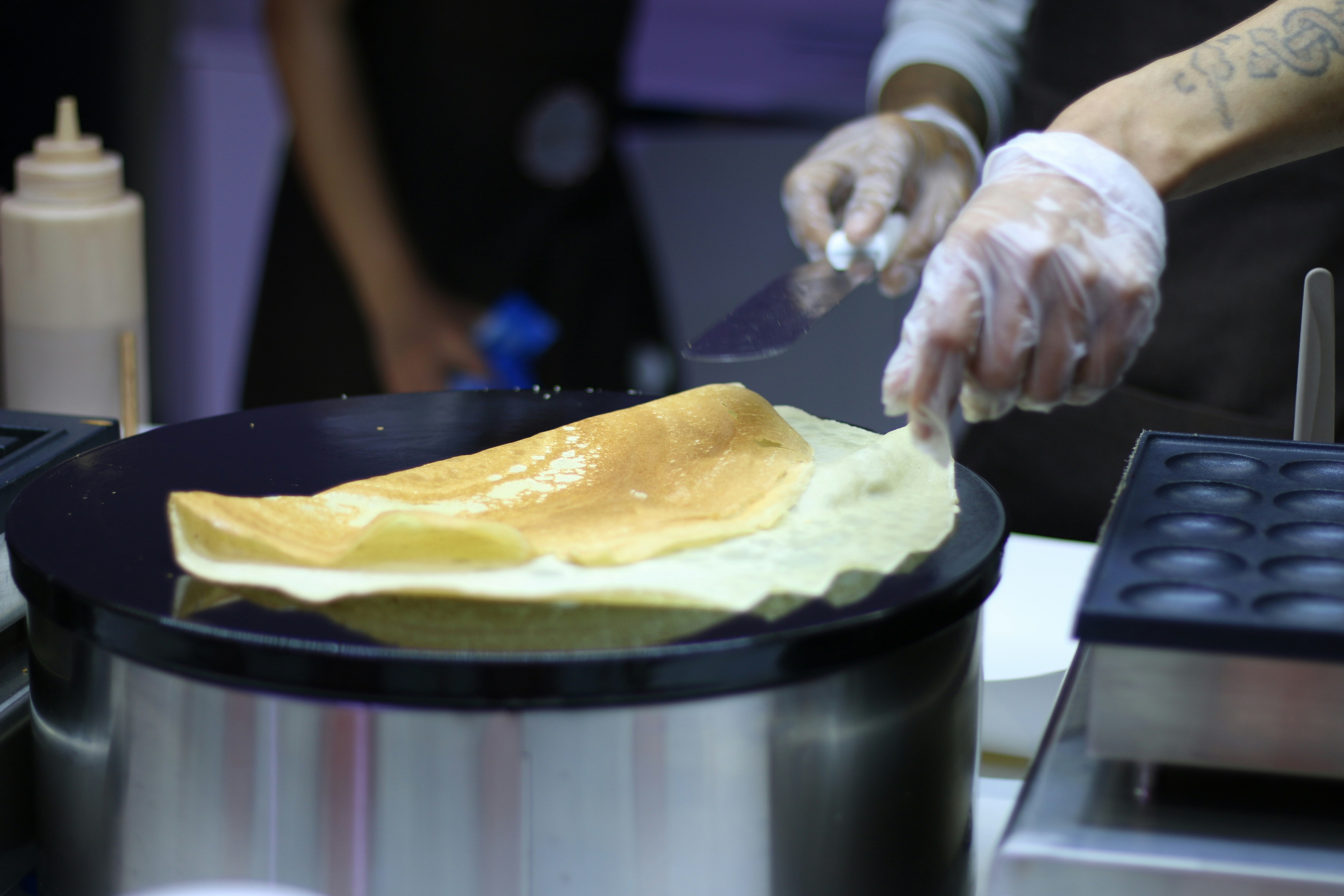 a person in a kitchen preparing food in a pan
