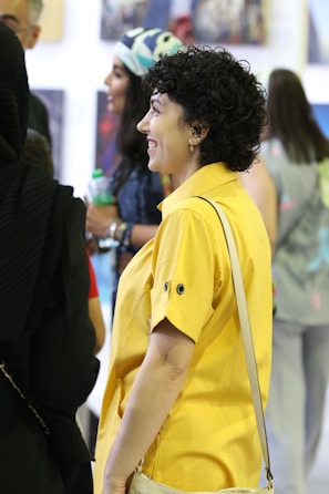 A vibrant scene from a lively exhibition with guests engaging and smiling.