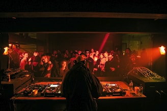 a dj in front of a large crowd of people