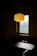 Cozy living room corner softly illuminated by a stylish pendant lamp from Luzara.