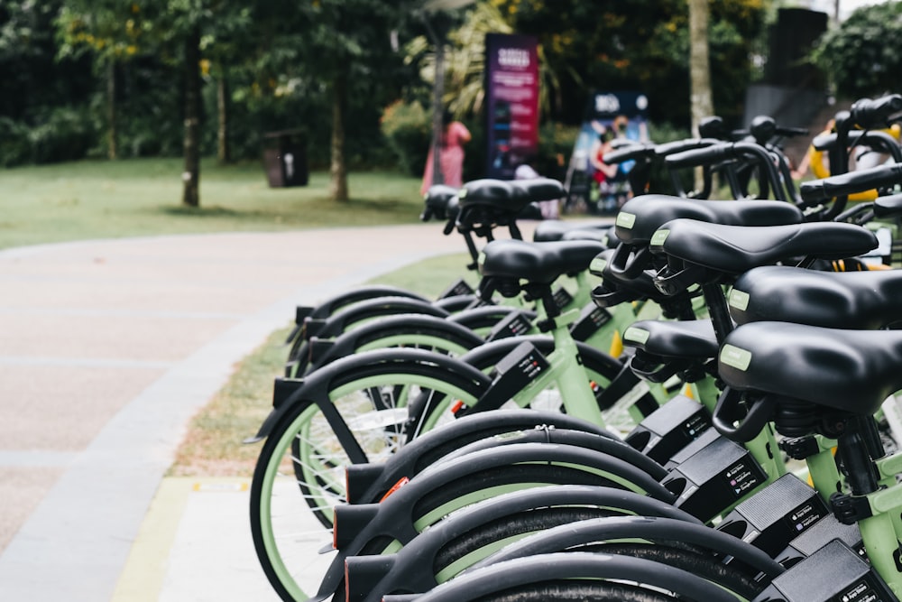 a row of green bikes parked next to each other