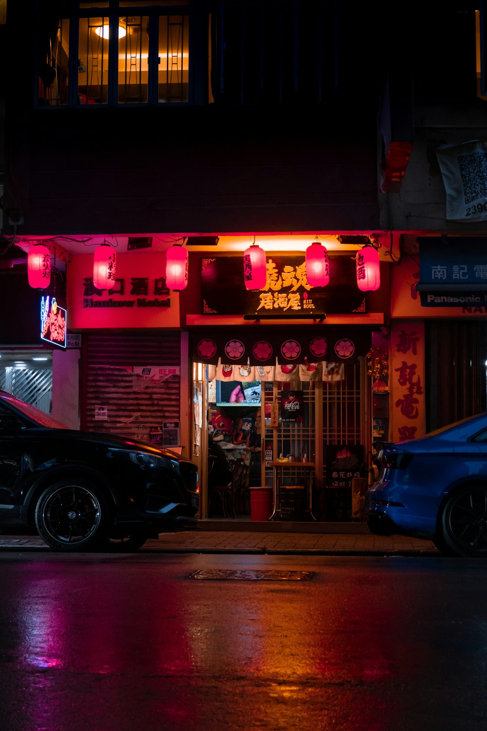 two cars parked in front of a chinese restaurant