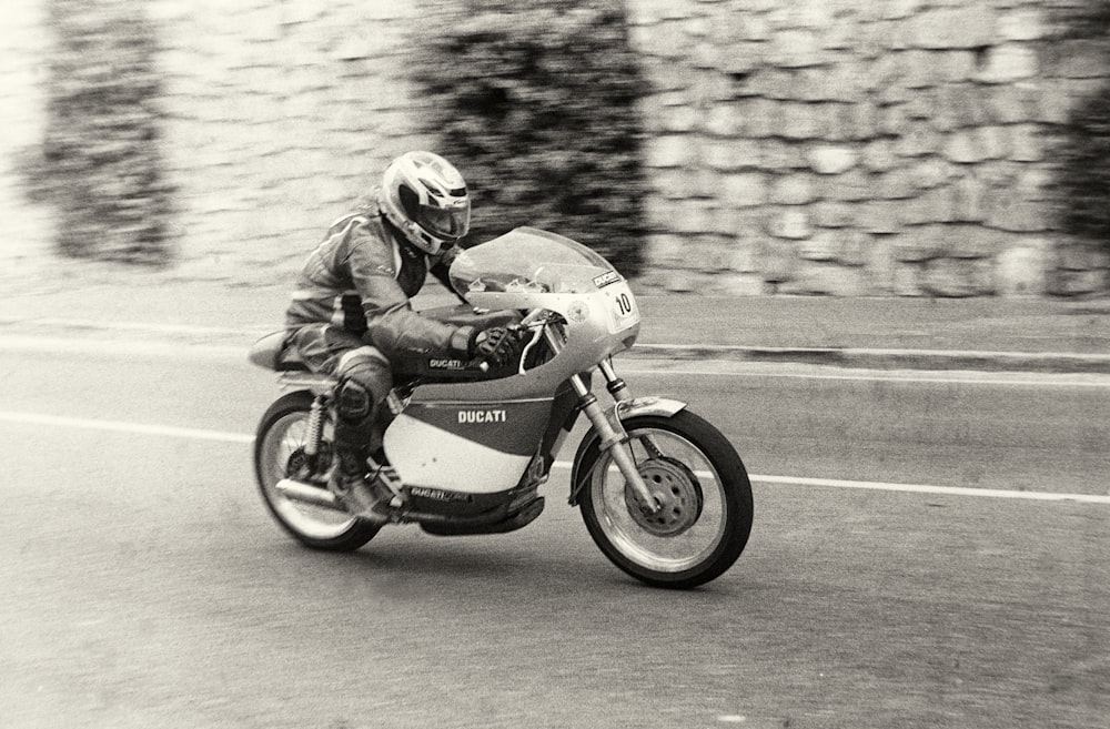 a man riding a motorcycle down a street