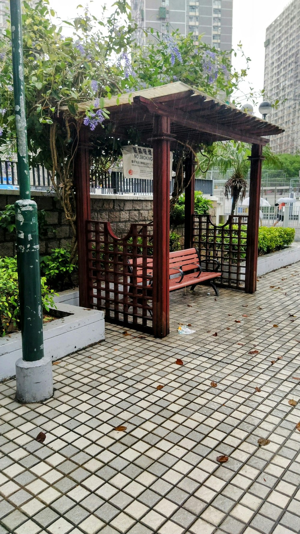a wooden bench sitting under a wooden arbor