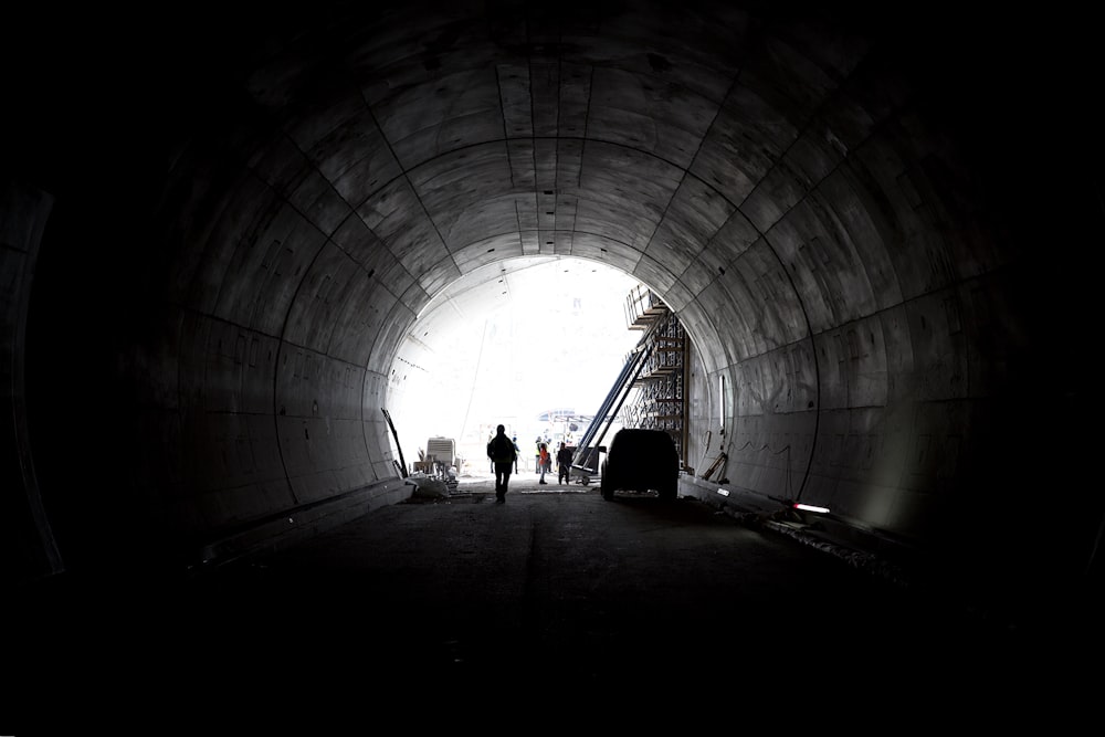 a man is standing in a dark tunnel