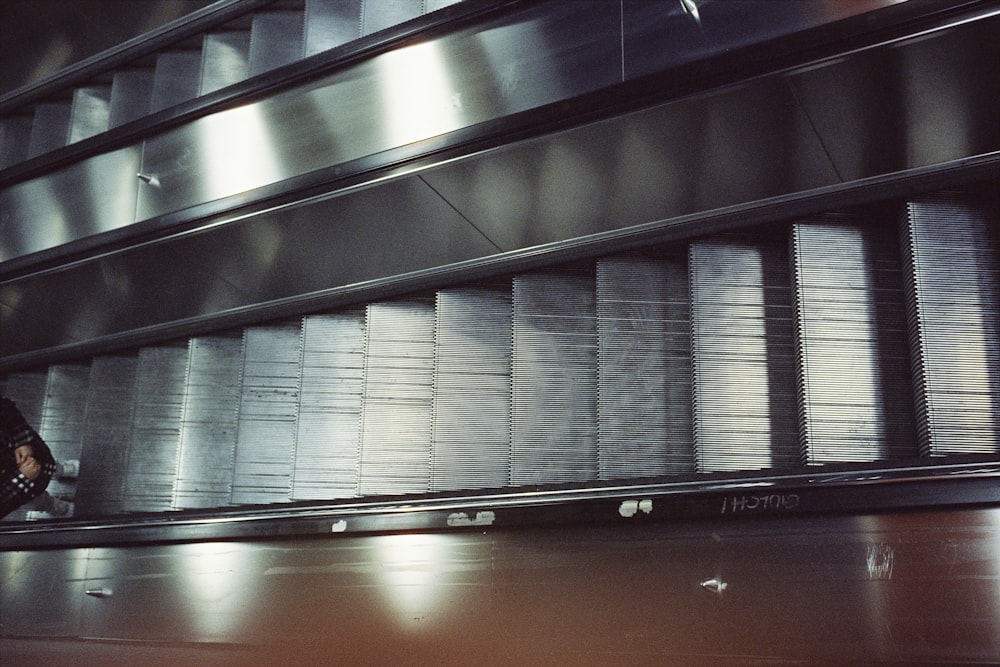 a person riding an escalator in a building