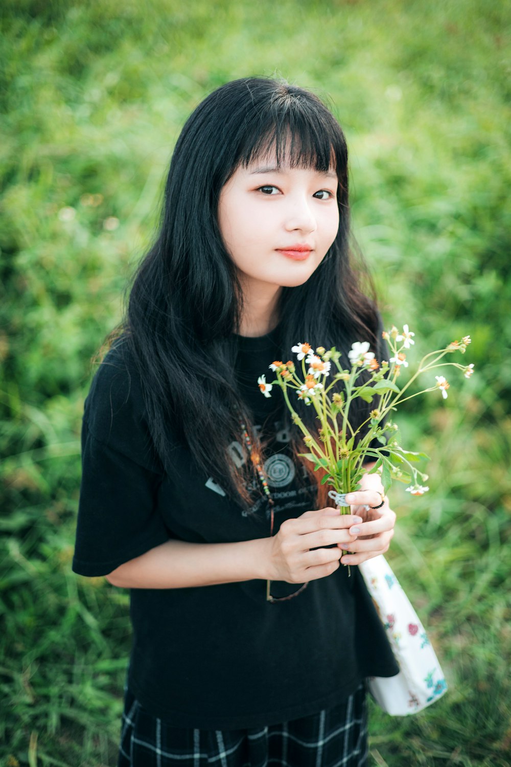 a woman holding a bouquet of flowers in her hands