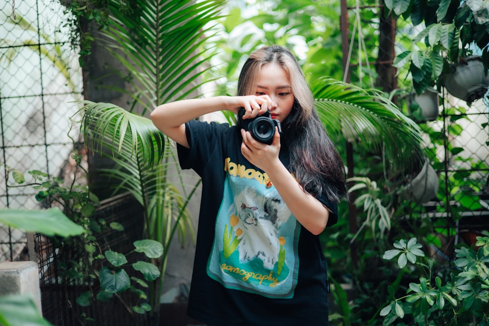 a woman taking a picture of herself with a camera