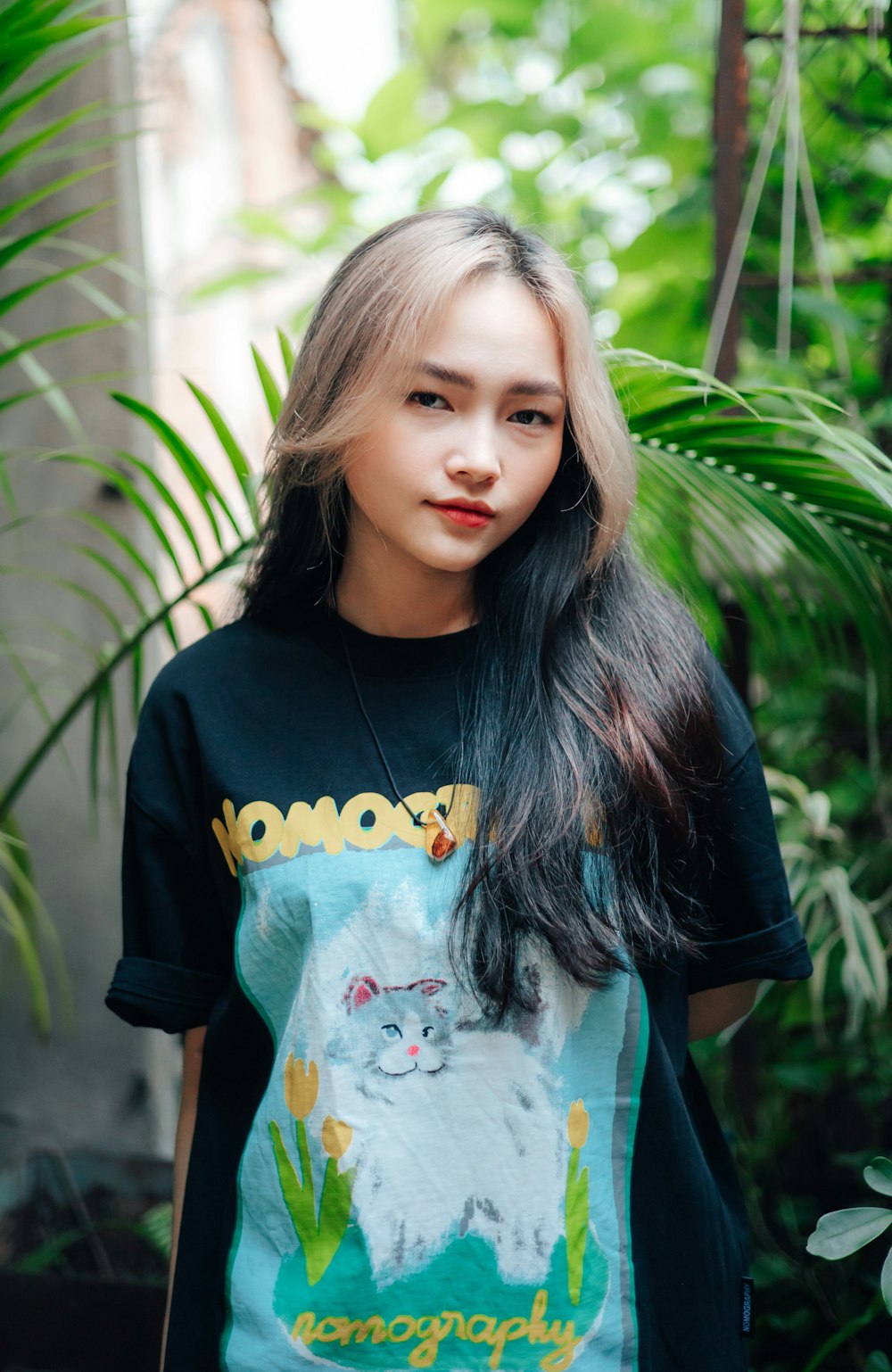 a woman with long hair wearing a t - shirt with a picture of a cat